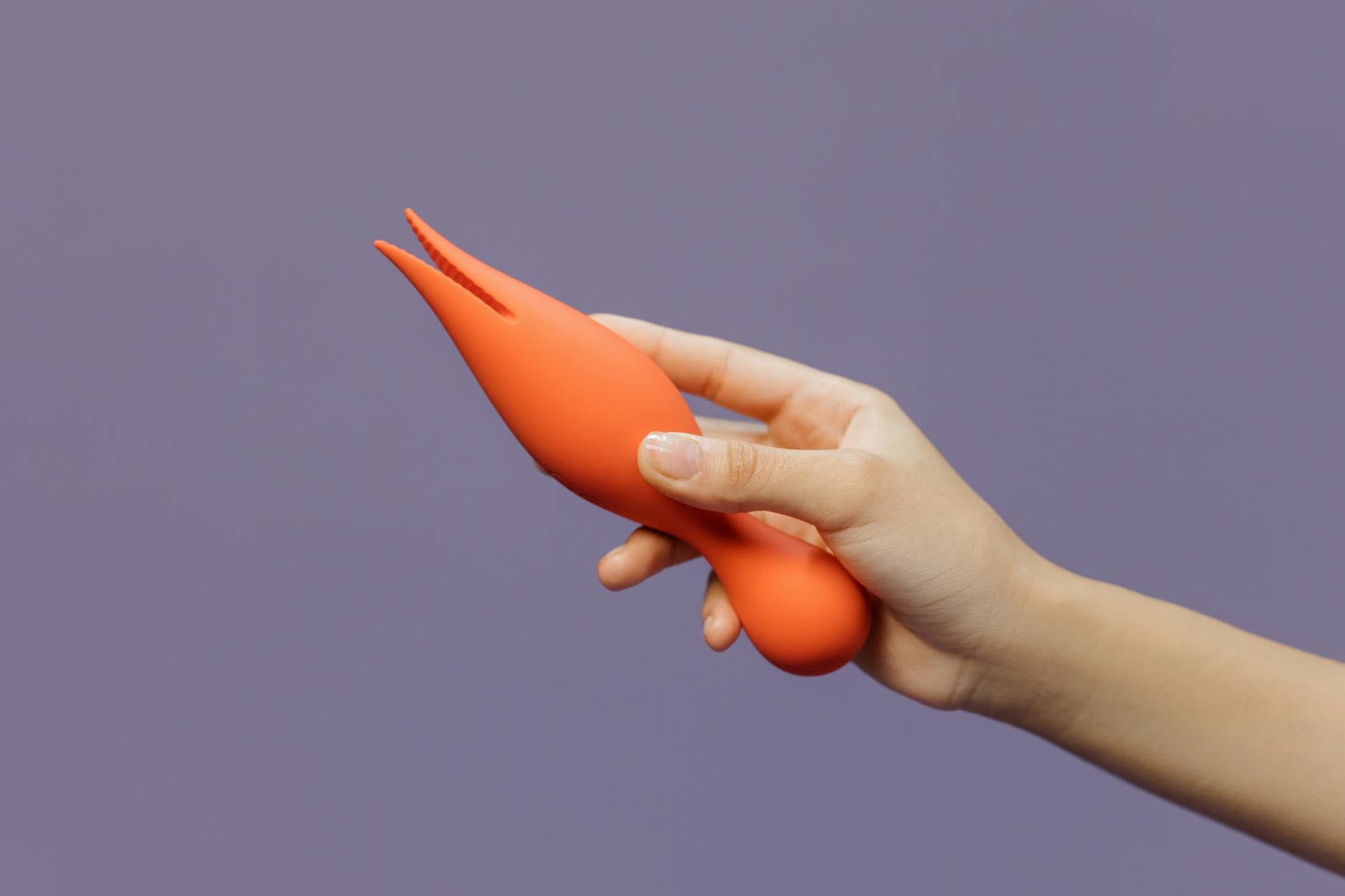 A close-up of hands holding a vibrator, symbolizing intimacy and partnership in long-term relationships.