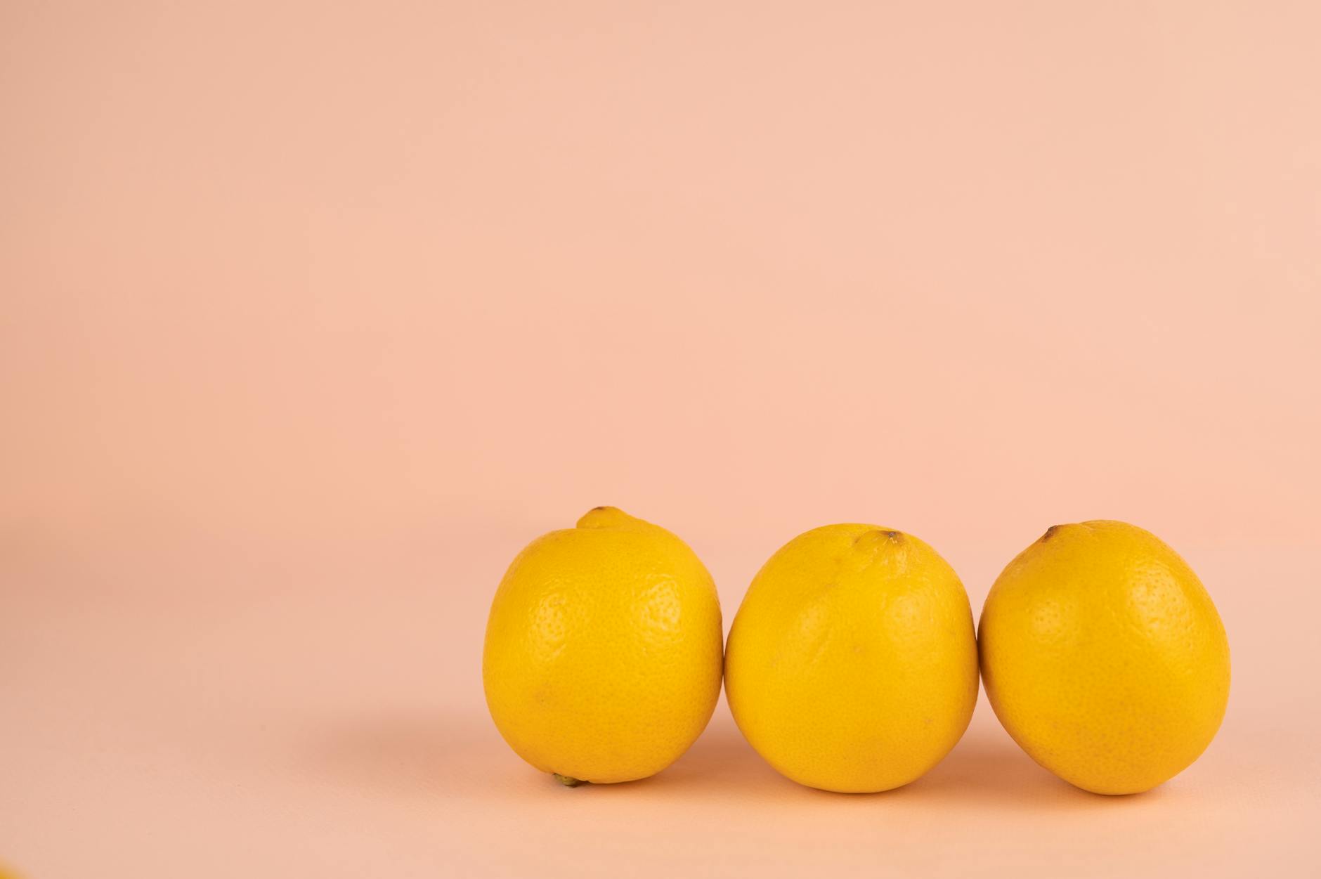 Two fresh lemons held in cupped hands, symbolizing gentle healing and recovery